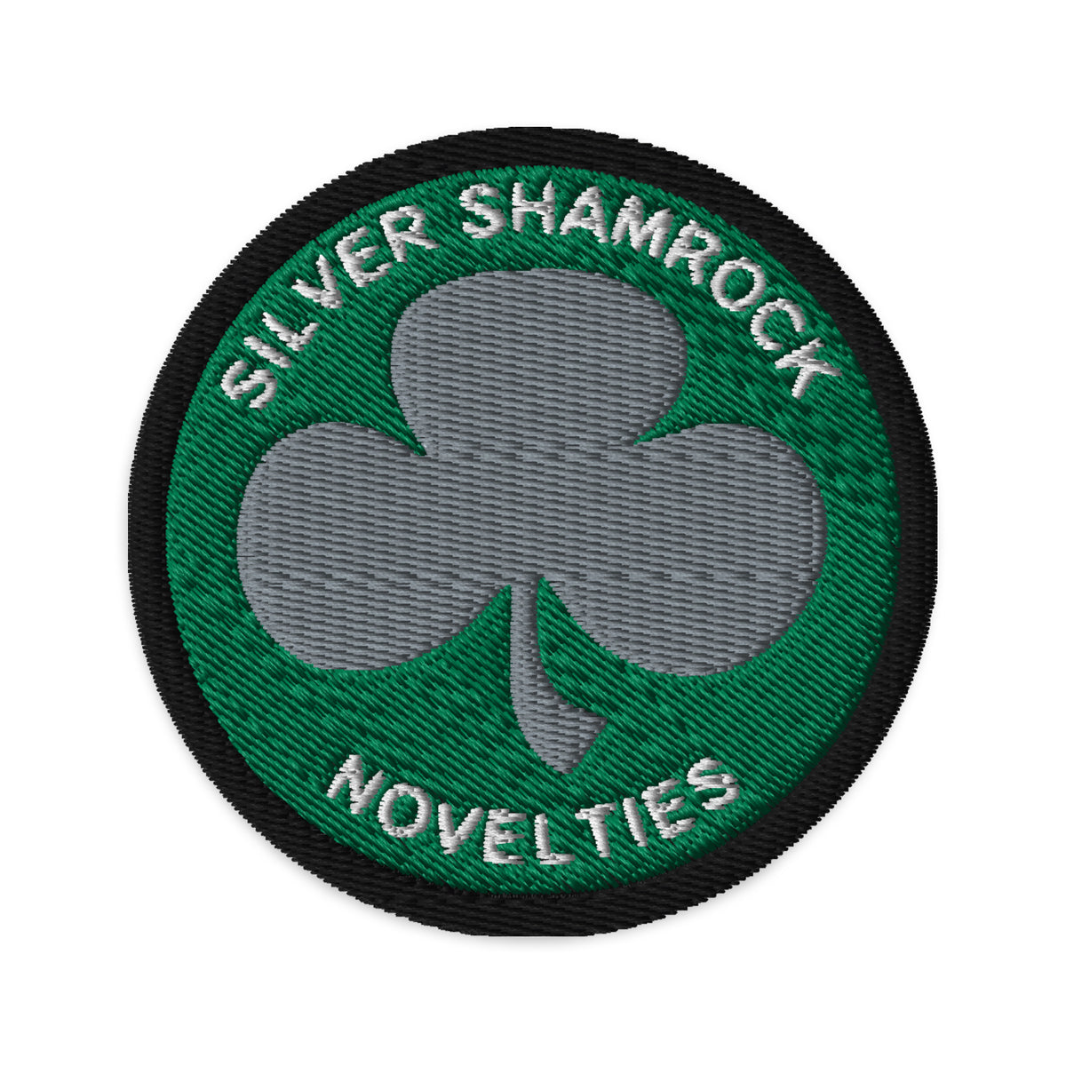 Circular embroidered patch featuring Silver Shamrock Novelties, front view