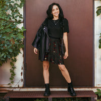 Skulls Bats Roses & Ravens pattern on women's skater skirt, front view