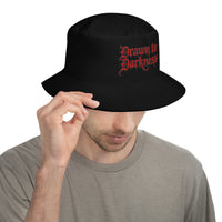Black bucket hat with Drawn to Darkness Horror embroidered artwork, front view