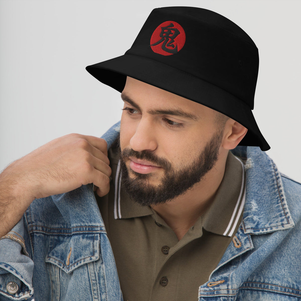 Black bucket hat with Demon Kanji 鬼 (Oni) embroidered artwork, left-front view