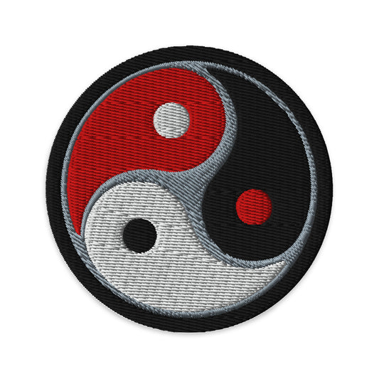 Circular embroidered patch featuring Triple Yin Yang, front view