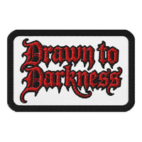Rectangle embroidered patch featuring Drawn to Darkness Iron On, front view