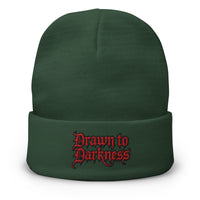 Green cuffed beanie with Drawn to Darkness Horror embroidered artwork, front view