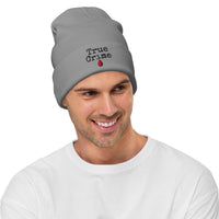 Gray cuffed beanie with True Crime Blood Drop embroidered artwork, front view