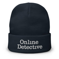 Navy cuffed beanie with Online Detective embroidered artwork, front view
