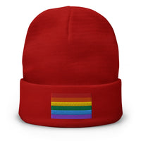 Red cuffed beanie with LGBTQ+ Pride Rainbow embroidered artwork, front view