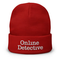 Red cuffed beanie with Online Detective embroidered artwork, front view
