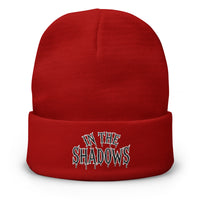 Red cuffed beanie with In The Shadows Horror embroidered artwork, front view