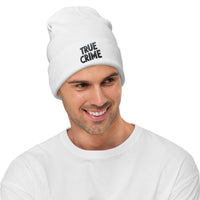 White cuffed beanie with Detective Style True Crime embroidered artwork, front view