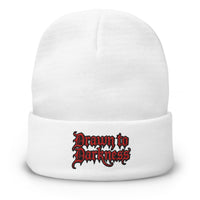 White cuffed beanie with Drawn to Darkness Horror embroidered artwork, front view