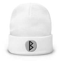 White cuffed beanie with Berkano Rune embroidered artwork, front view
