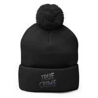 Black pom-pom beanie with Detective Style True Crime embroidered artwork, front view
