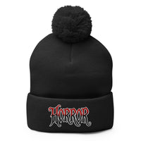 Black pom-pom beanie with House of Horrors embroidered artwork, front view