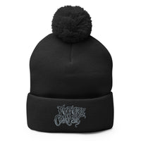Black pom-pom beanie with Future Corpse embroidered artwork, front view