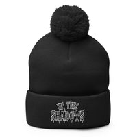 Black pom-pom beanie with In The Shadows embroidered artwork, front view