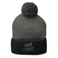 Black pom-pom beanie with Detective Style True Crime embroidered artwork, front view