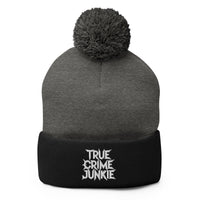Black pom-pom beanie with True Crime Junkie embroidered artwork, front view