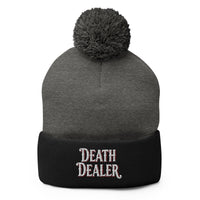 Black pom-pom beanie with Death Dealer True Crime embroidered artwork, front view