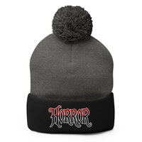 Black pom-pom beanie with House of Horrors embroidered artwork, front view