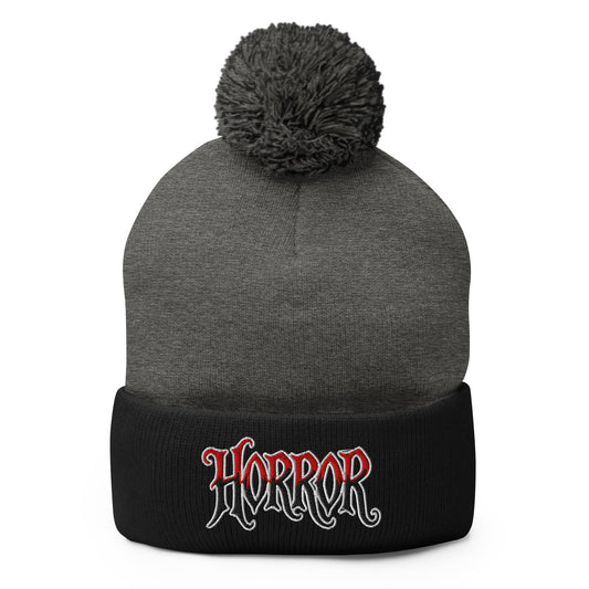 Black pom-pom beanie with House of Horrors embroidered artwork, front view