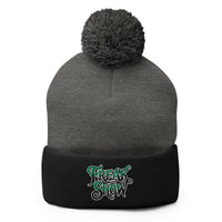 Black pom-pom beanie with Freak Show embroidered artwork, front view