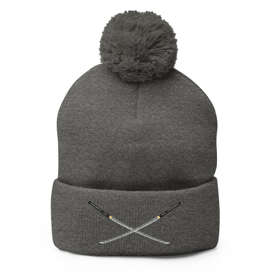 Gray pom-pom beanie with Dual Samurai Swords Anime Warrior embroidered artwork, front view