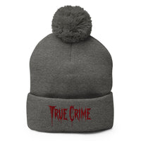 Gray pom-pom beanie with Blood Drip True Crime embroidered artwork, front view