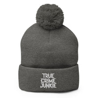 Gray pom-pom beanie with True Crime Junkie embroidered artwork, front view