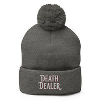 Gray pom-pom beanie with Death Dealer True Crime embroidered artwork, front view