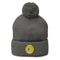 Gray pom-pom beanie with Nine Ball Line Billiards embroidered artwork, front view