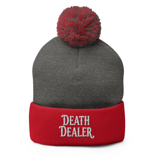 Red pom-pom beanie with Death Dealer True Crime embroidered artwork, front view