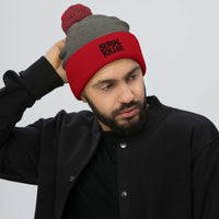 Red pom-pom beanie with Serial Killer True Crime embroidered artwork, front view