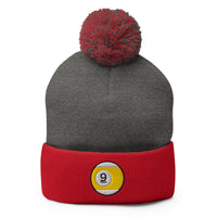 Red pom-pom beanie with Nine Ball Line Billiards embroidered artwork, front view