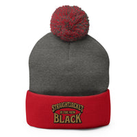 Red pom-pom beanie with Straightjacket Is the New Black embroidered artwork, front view
