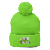 Green pom-pom beanie with Death Dealer True Crime embroidered artwork, front view