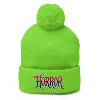 Green pom-pom beanie with House of Horrors embroidered artwork, front view
