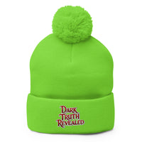 Green pom-pom beanie with Dark Truth Revealed embroidered artwork, front view