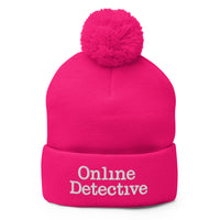 pom-pom beanie with Online Detective embroidered artwork, front view
