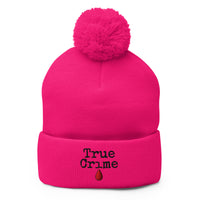 pom-pom beanie with True Crime Blood Drop embroidered artwork, front view