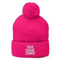 pom-pom beanie with True Crime Junkie embroidered artwork, front view