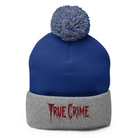 Gray pom-pom beanie with Blood Drip True Crime embroidered artwork, front view