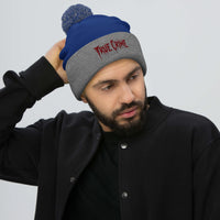 Gray pom-pom beanie with Blood Drip True Crime embroidered artwork, front view