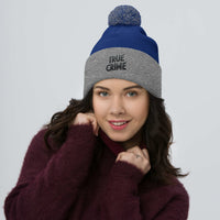 Gray pom-pom beanie with Detective Style True Crime embroidered artwork, front view