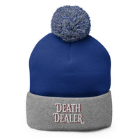 Gray pom-pom beanie with Death Dealer True Crime embroidered artwork, front view