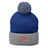 Gray pom-pom beanie with Dark Truth Revealed embroidered artwork, front view