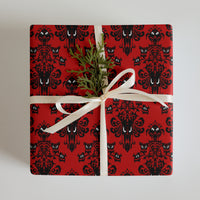 Red Haunted Mansion pattern on wrapping paper sheets, front product mockup