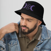 Black bucket hat with Purple Pagan Triple Moon Goddess embroidered artwork, left-front view
