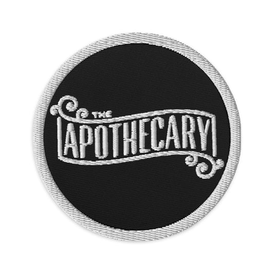 Circular embroidered patch featuring The Apothecary, front view