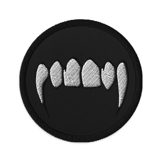 Circular embroidered patch featuring Vampire Fangs, front view
