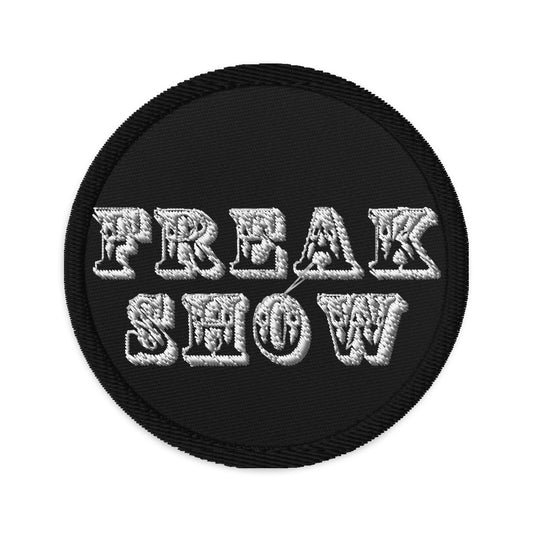 Circular embroidered patch featuring Freak Show, front view